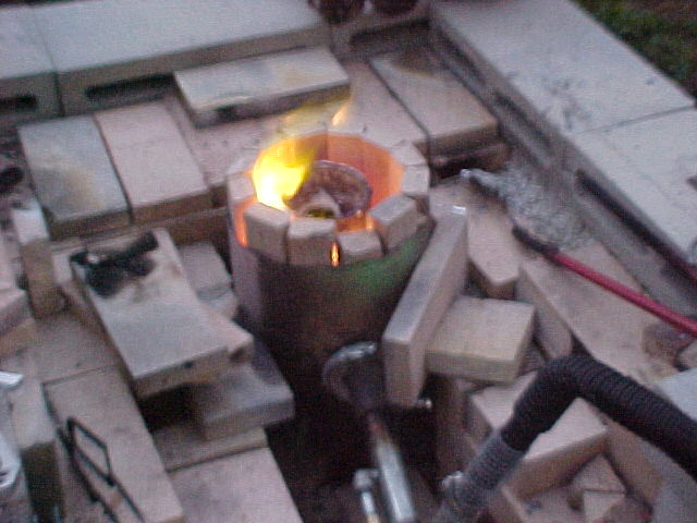 feontank furnace with burner going and melting aluminum.jpg